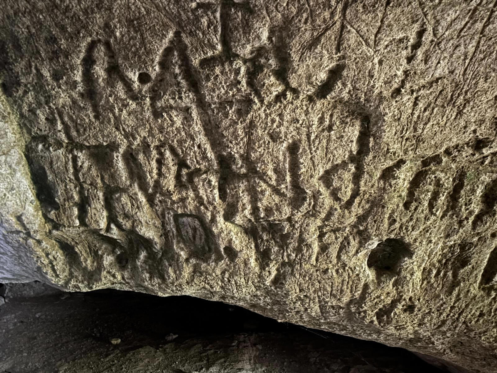 Carved inscriptions and markings inside Għar Ħanżir