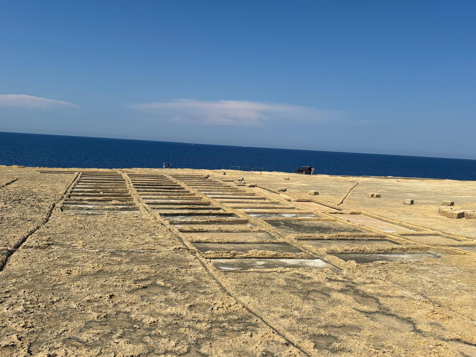 Panoramic view of the geometric clockmaker salt pans facing the deep blue Mediterranean sea