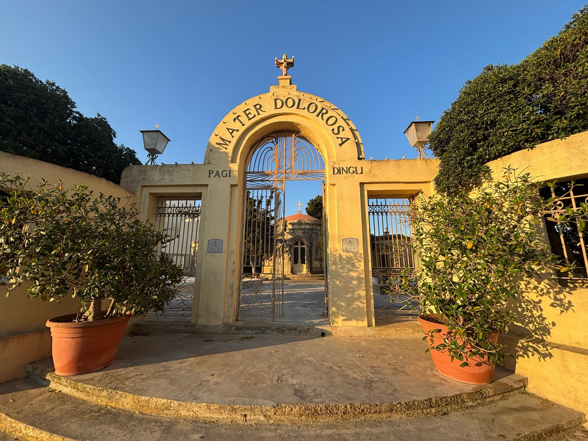 High perimeter walls and limestone tombs of the Mater Dolorosa Cemetery in Dingli