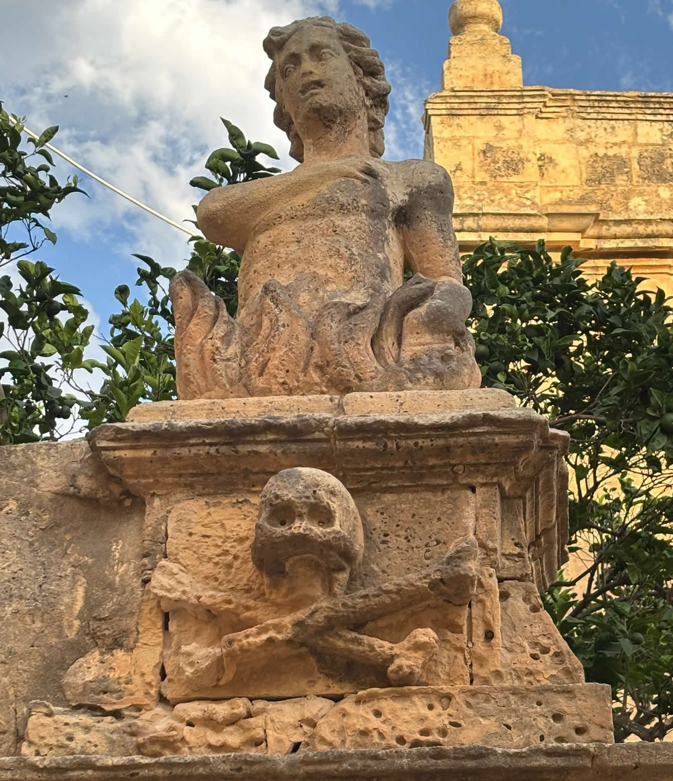 Funerary stone carving of skull and crossbones on the parvis of St. Luke's Chapel, Zurrieq