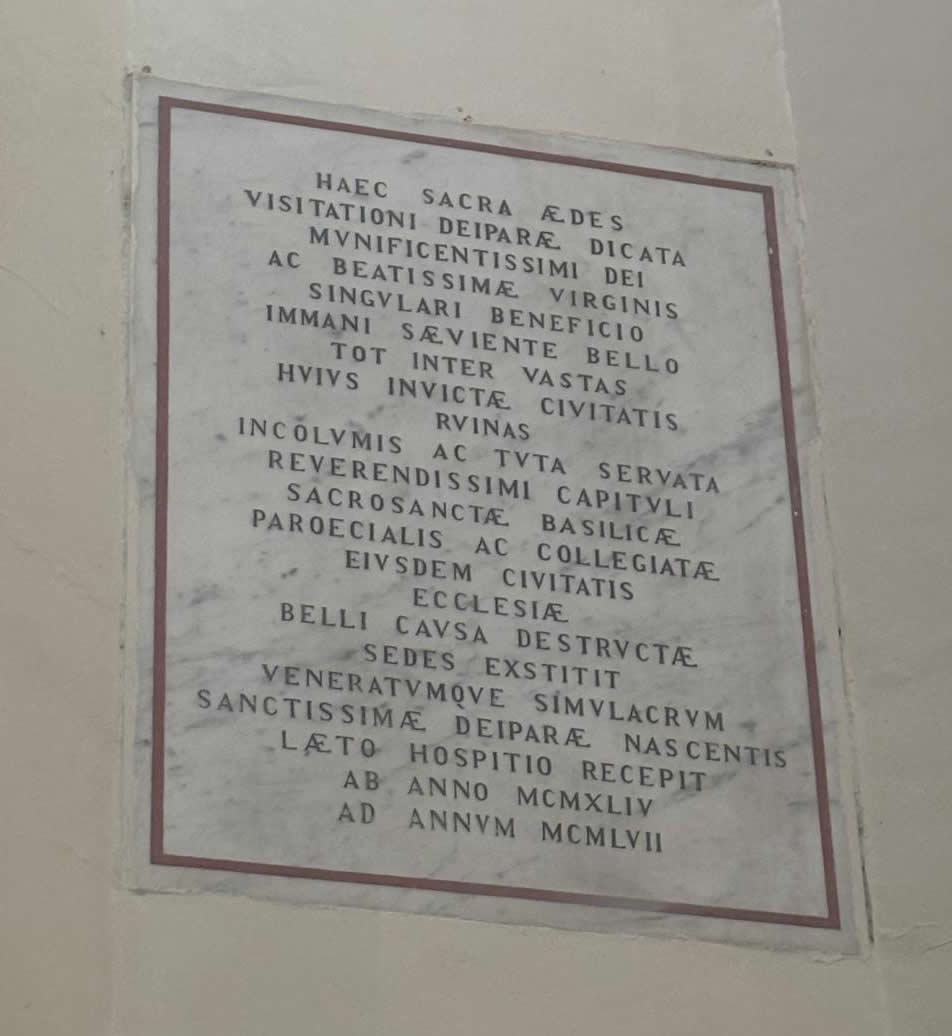 Latin marble commemorative plaque inside the Church of St Philip in Senglea recording its survival in World War II and hosting the Maria Bambina statue