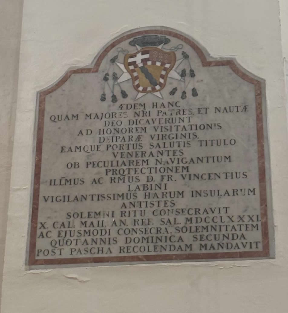 Latin marble commemorative inscription plaque showing the coat of arms of Bishop Vincenzo Labini inside the Church of St Philip in Senglea Malta