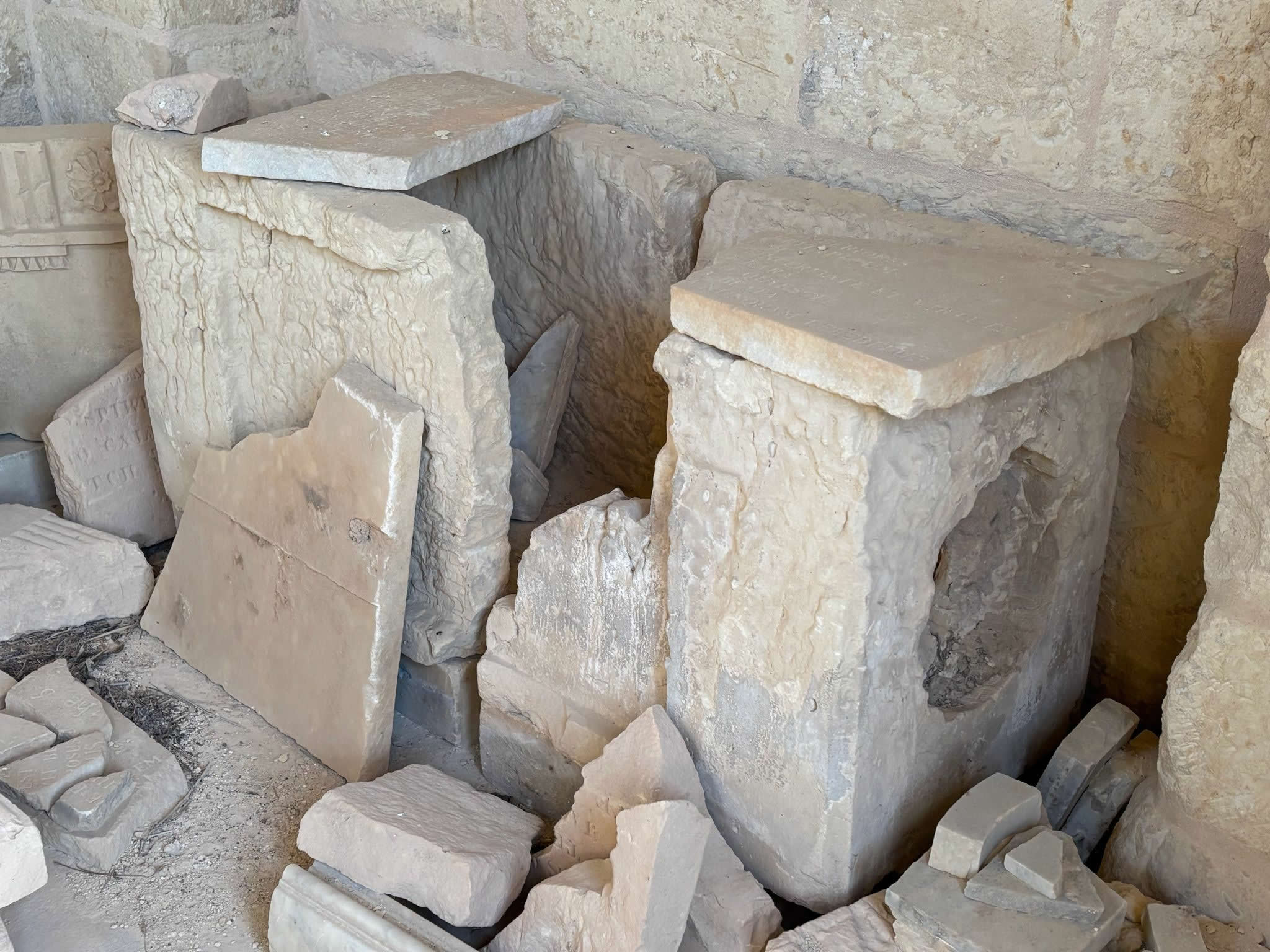 Fragmented limestone vault blocks and structural debris piled inside the chapel