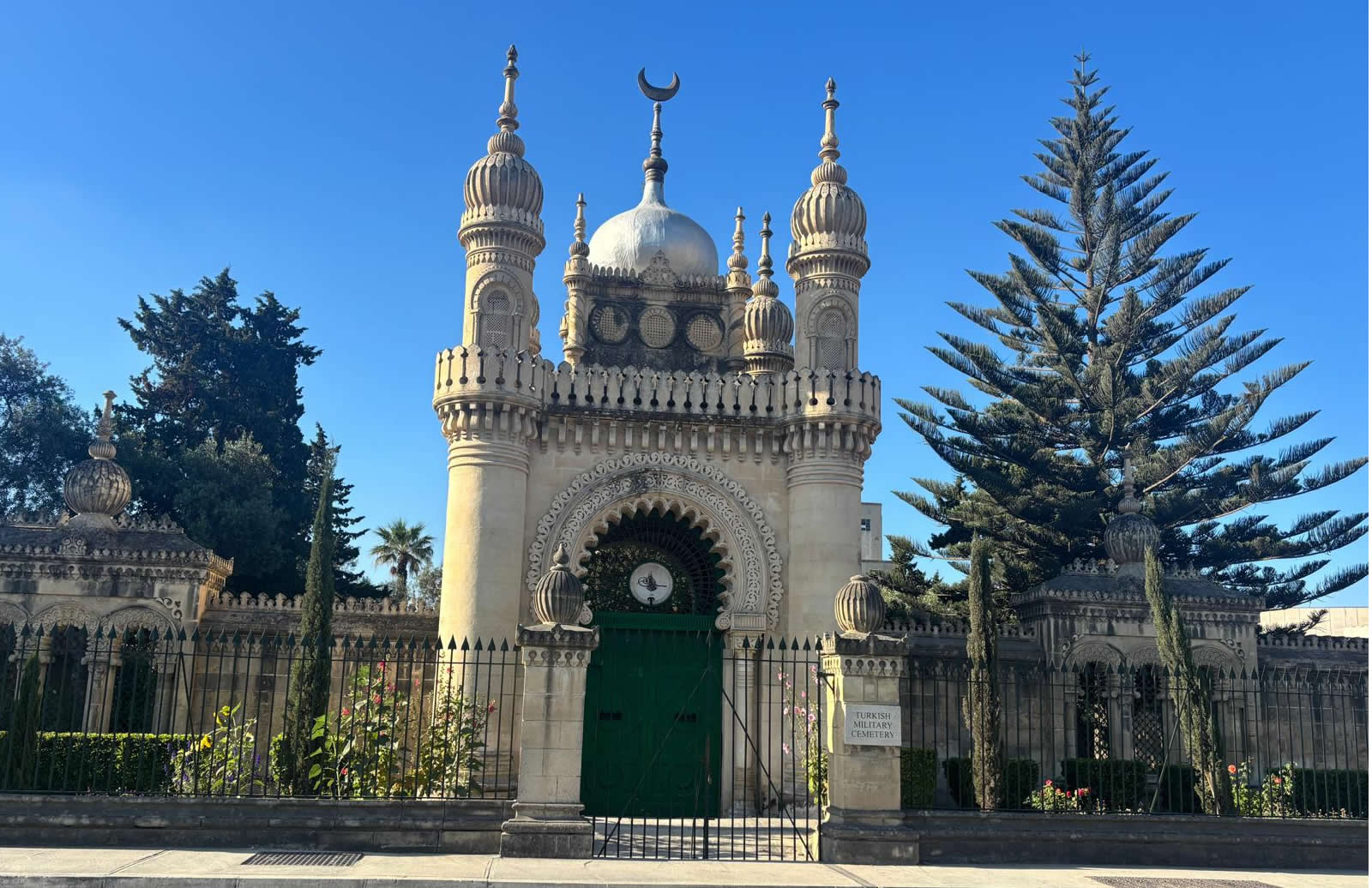 The main entrance gate of the Turkish Military Cemetery in Marsa showing limestone horseshoe arches and minarets