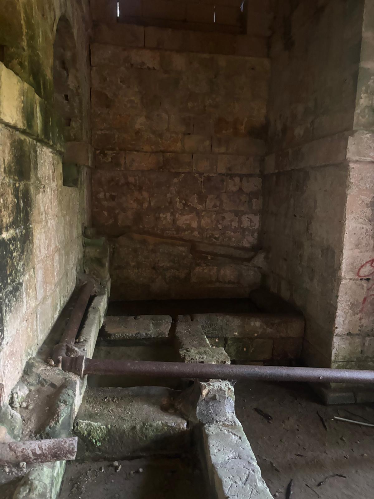 Detail of historical cast iron water pipes laid inside the stone masonry chambers of Ghajn Hammiem