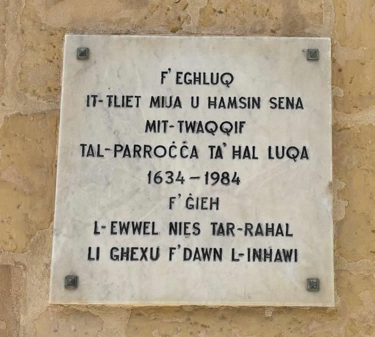 Commemorative marble slab on a stone wall marking the 350th anniversary of the Luqa parish 1634 to 1984