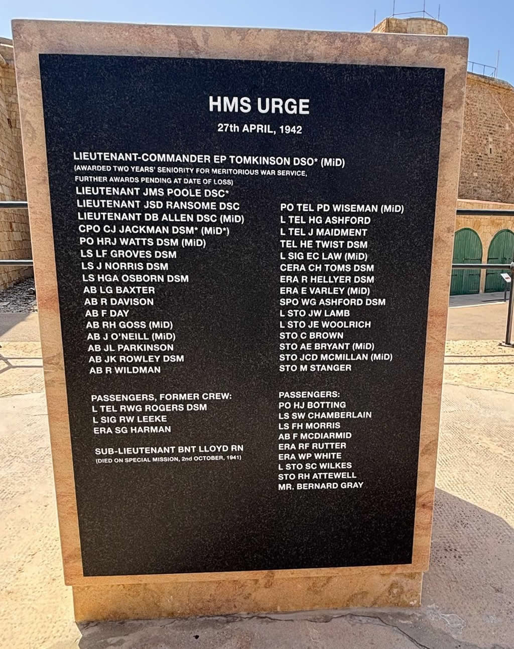 Close-up view of the black granite plaque on the side of the monument listing the names of HMS Urge crew and passengers.