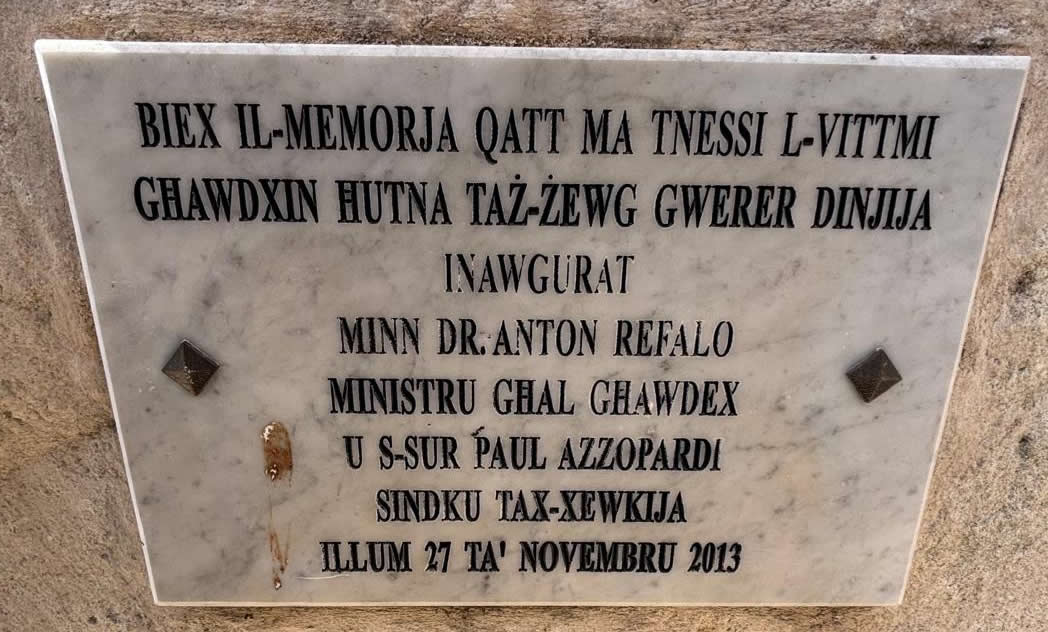 Commemorative marble plaque inscription at the base of the Xewkija War Memorial