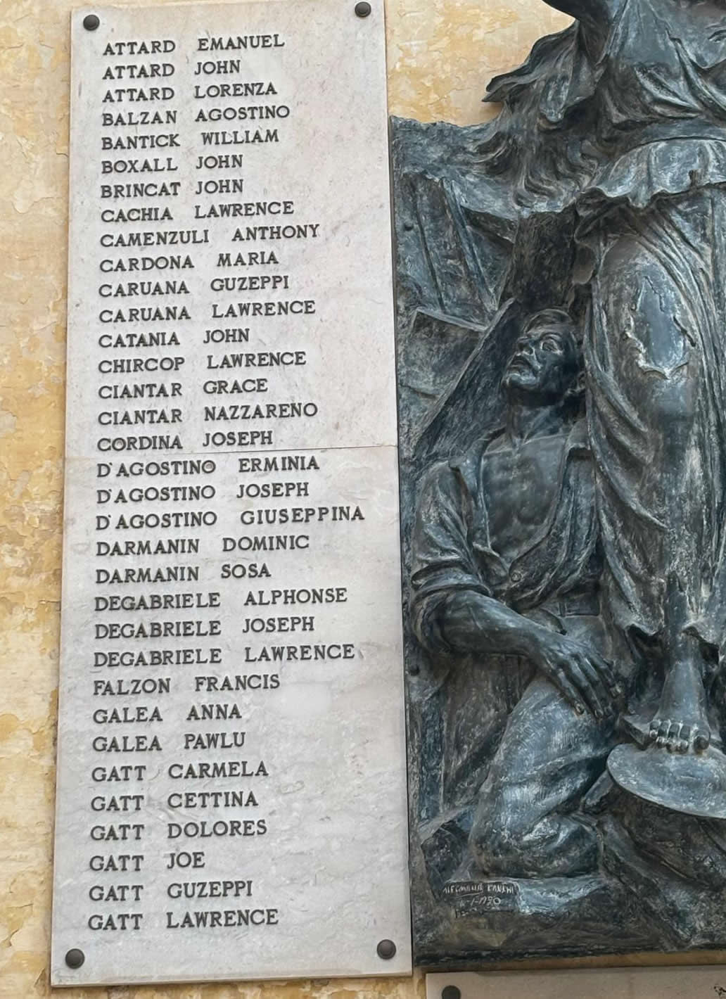 Close-up view of the left marble panel on the Birgu war memorial containing names from Attard to Gatt.