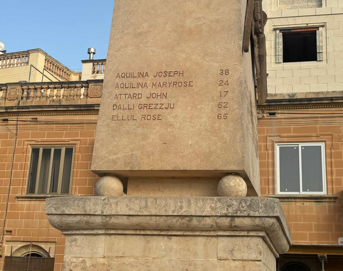 First panel face of the Qrendi War Memorial obelisk listing names Aquilina to Ellul with ages
