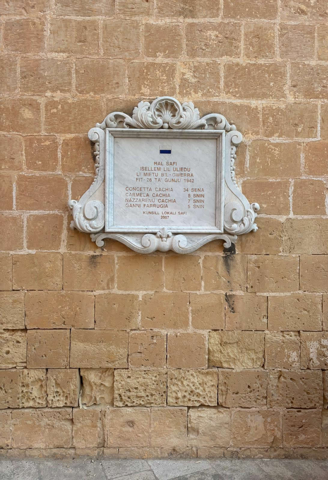 Overall view of the Safi Malta World War II War Memorial on the boundary wall beside the parish church