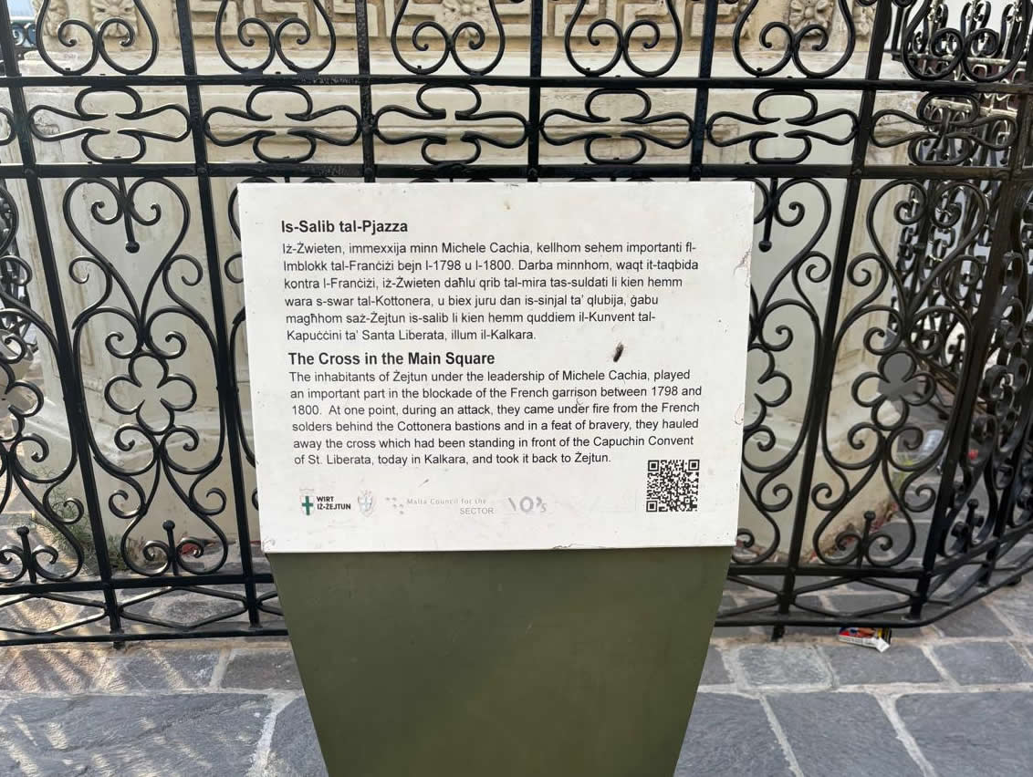Information board in Żejtun main square describing the cross brought back during the French Blockade