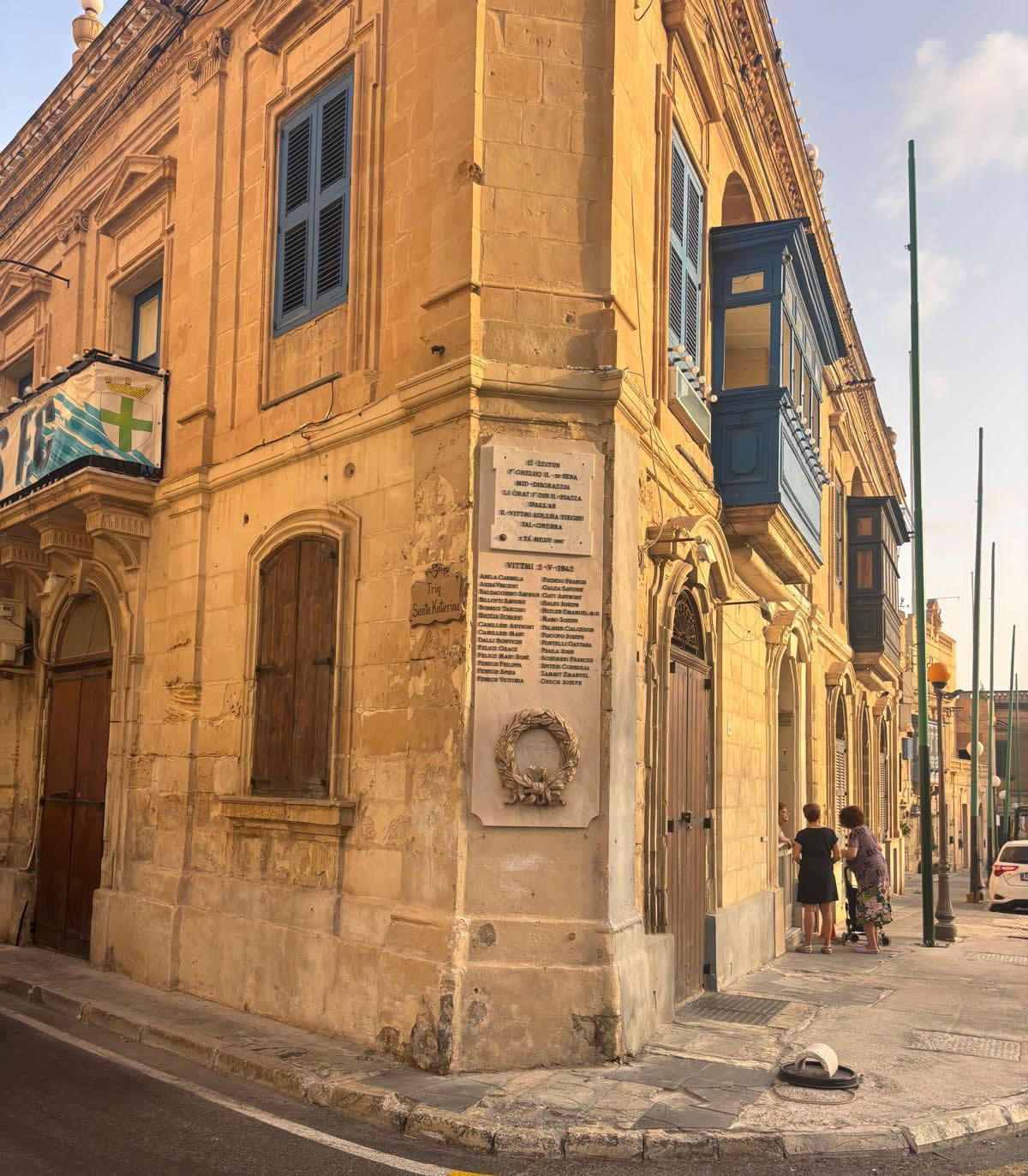 Overall view of the Żejtun War Memorial mounted on a historic corner building in Triq Santa Katerina